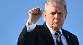 Trump gestures as he boards Air Force One on March 1, 2026 Mandel Ngan/AFP